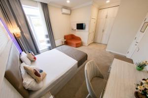 a small room with a bed and a table at Zimmer Boutique Hotel in Baku