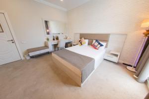 a bedroom with a bed and a desk in it at Zimmer Boutique Hotel in Baku