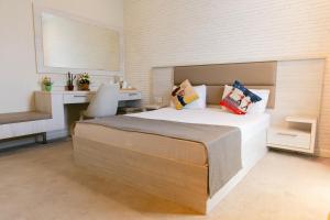 a bedroom with a large bed and a desk at Zimmer Boutique Hotel in Baku