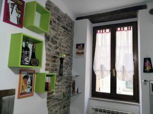 a room with a window and some pictures on the wall at Da La Mae in Città di Castello