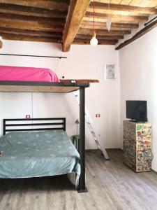 a bedroom with a bunk bed and a television at Da La Mae in Città di Castello