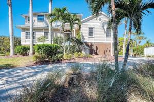 a house with palm trees in front of a driveway at Manatee Cove in Englewood