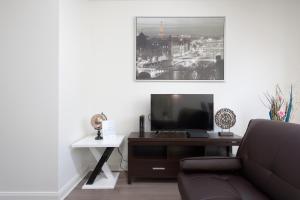 a living room with a couch and a tv at Fantastic Philly Fully Furnished Apartments in Philadelphia