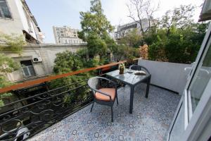a balcony with a table and chairs on a balcony at Zimmer Boutique Hotel in Baku