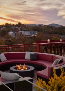 a living room with a couch and a fire pit at The Radical in Asheville