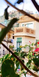 a view of a building from behind a plant at Casa Pancrazia in Taormina