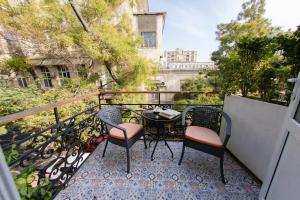 a balcony with two chairs and a table on a balcony at Zimmer Boutique Hotel in Baku