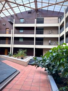 a building with a person on a bike in the courtyard at Modern Family Apartment 20mins from Disney / 45mins from Paris in Lognes