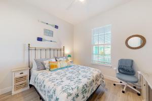a bedroom with a bed and a desk and a chair at Lavender Life in Saint James City