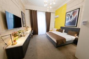a hotel room with a bed and a television at Zimmer Boutique Hotel in Baku