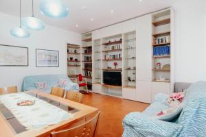 a living room with a table and chairs and a tv at Al Castello di San Giusto free garage in Trieste