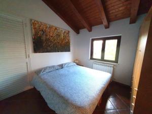 Un pat sau paturi într-o cameră la Casetta Pegaso
