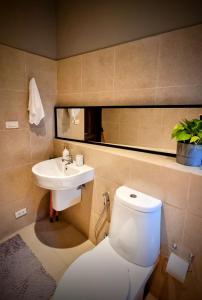a bathroom with a toilet and a sink at Horizon Vista Pool Villa Family Retreat Bangtao in Phuket