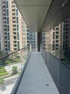 a walkway in a building with tall buildings at Dreamy 2BR Haven, Downtown Bliss in Dubai