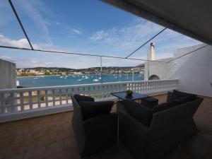 a balcony with chairs and a view of the water at Sea Front Sophia Porto Rafti in Porto Rafti