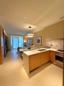 une grande cuisine avec un salon et une salle à manger dans l'établissement Dreamy 2BR Haven, Downtown Bliss, à Dubaï