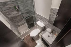 a small bathroom with a toilet and a sink at Magnificent 5BR apartment in NYC! in New York