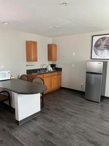 a kitchen with a table and a refrigerator at High Falls Inn & Suites in High Falls