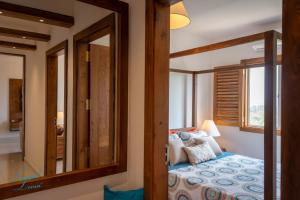 a bedroom with a bed with a large mirror at Lavish Livin’ in Galle