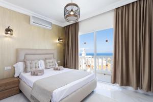 a bedroom with a large bed and a large window at Villa Exotica in Adeje +30 photos