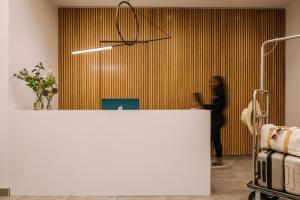 a woman standing in an office with a white counter at Sonder Maisonneuve in Montreal