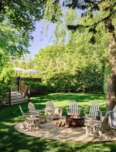 a group of chairs and a fire pit in a yard at Journey East Hampton in East Hampton