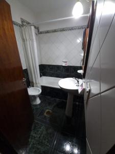a small bathroom with a sink and a toilet at Espacio Verde in Salta