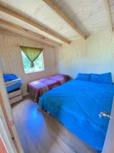 - une chambre avec 2 lits et une fenêtre dans l'établissement Casa de campo, à Lago Ranco