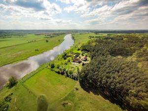 an aerial view of a house next to a river at Agroturystyka Nad Wartą in Skwierzyna