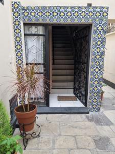 a house with a potted plant in front of a door at Espacio Verde in Salta