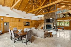 a living room with a couch and a table and a fireplace at Gorgeous North Fork Cabin Near Bass Lake! in North Fork