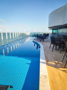 a swimming pool on the roof of a building at RN Studio Premium in Maceió