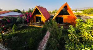 a couple of small wooden homes in a yard at Begonwil Bungalow apart demre in Demre
