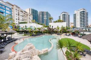 a large swimming pool in a resort with buildings at Gibraltar Luxury with Rooftop Pools & Views in Gibraltar