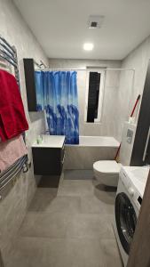 a bathroom with a sink and a toilet and a tub at Kavoliuko 14 in Vilnius +4 photos