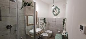 a bathroom with a toilet and a sink and a mirror at Il Mulino B&B in Rivara