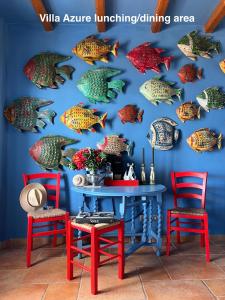 a wall mural of fish on a blue wall at VillaRentalKoufonisiGreece in Koufonisia