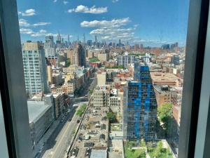 a view of a city from a window at LES is MORE stunning views! in New York