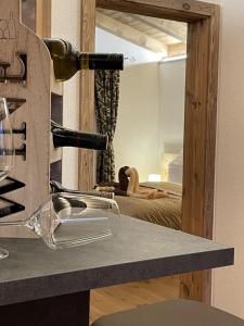 a counter with a wine bottle and a mirror at Alpenchalet Waldruhe in Scheffach