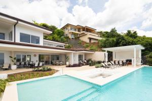an image of a house with a swimming pool at CASA AYLA A - stunning 5BR Ocean view house & infinity pool in Flamingo in Playa Flamingo