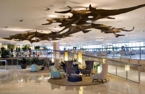 a lobby with a large sculpture of a fish on the ceiling at Suíte Com Vista pro Mar no Hotel Nacional in Rio de Janeiro