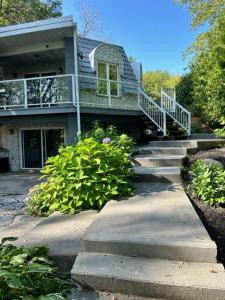 a house with a staircase leading up to a house at Waterfront Cottage in Muskoka in Severn