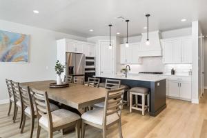 una cocina con una gran mesa de madera y sillas en Sunsets and Sandcastles townhouse en St. George