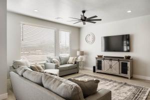 a living room with a couch and a flat screen tv at Sunsets and Sandcastles townhouse in St. George