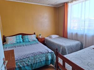 Postel nebo postele na pokoji v ubytování HOSTAL VALDIVIA