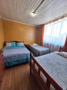 Postel nebo postele na pokoji v ubytování HOSTAL VALDIVIA