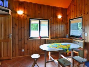 a room with a table and chairs and wooden walls at Comfortable holiday home on a private property Kolobrzeg in Kołobrzeg