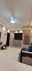 a bedroom with a bed and a living room at Apartamento único e aconchegante! in Cabo Frio