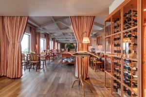 a dining room with a table and chairs and wine racks at Solar de Vila Meã in Barcelos
