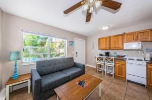 a living room with a couch and a kitchen at Blue Water Beachside Villa 6 in Clearwater Beach